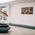 abstract painting on wall in front of staircase